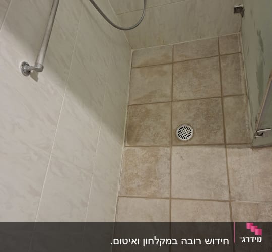 מקלחת עם אריחים ומוט אחיזה